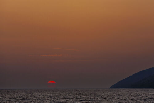 sunset photograph captures the serene beauty of Golden Cape (Zlatni Rat) Beach on Brac Island in Croatia.