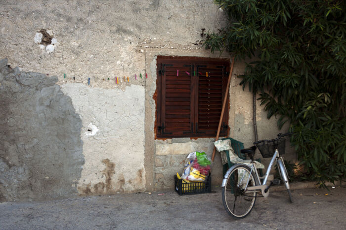 An old, weathered house with cracked and patched walls