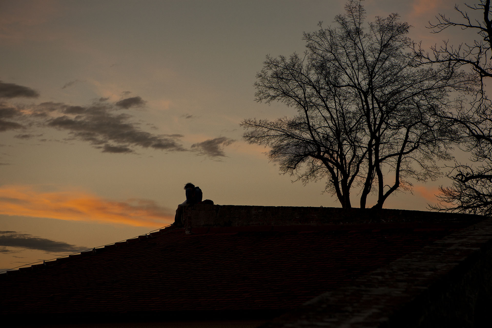 Sky is painted with soft hues of orange and pink