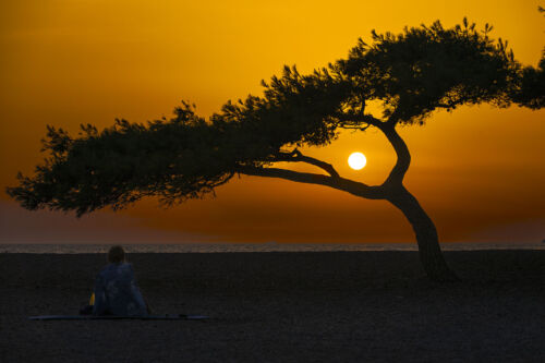 As the sun dips toward the horizon over the iconic Zlatni Rat beach