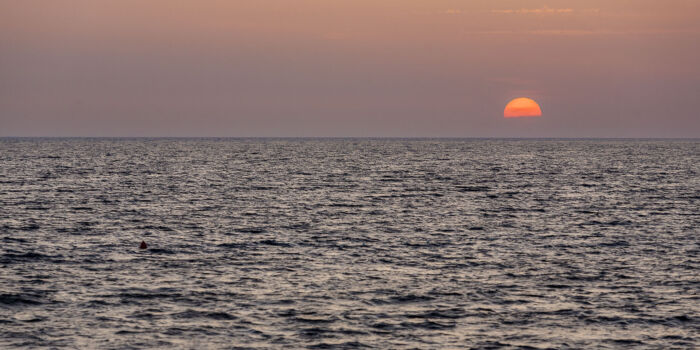 Sun dips below the horizon off the coast of Bol