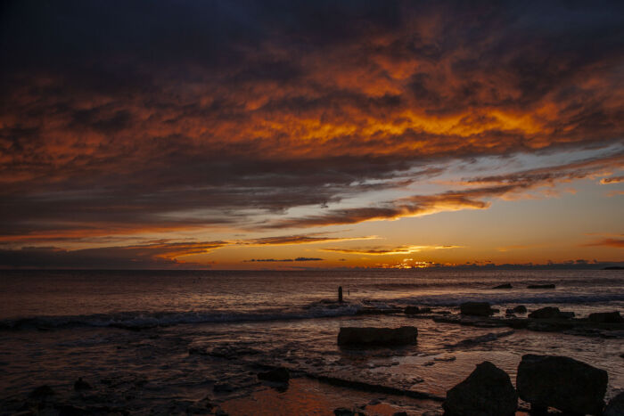 Sky blazes with an otherworldly palette of fiery oranges