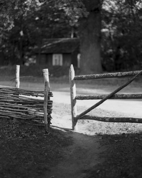 Rustic Serenity: Vintage Black and White Farmhouse Gate Photography - Where Time Stands Still